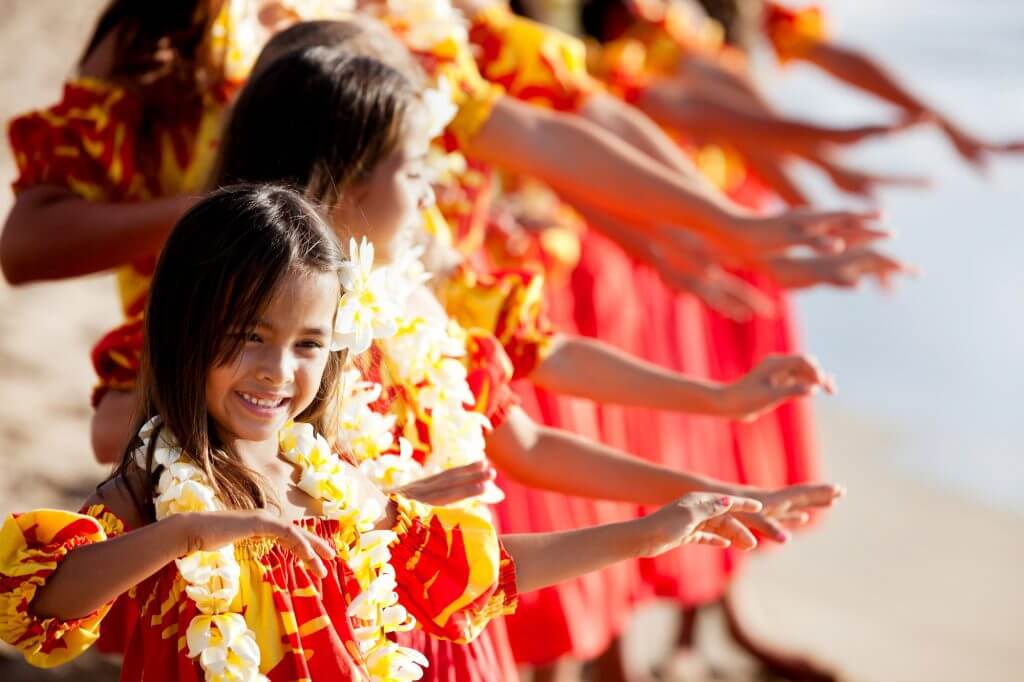 One of the best free things to do in Oahu with kids is see a hula show. Image of child hula performers.