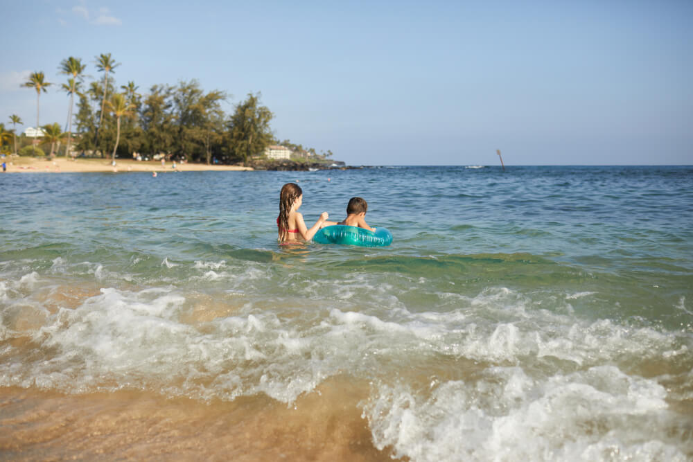 50 Best Places to Visit in Hawaii with your Family featured by top Hawaii blog, Hawaii Travel with Kids: Poipu Beach is a kid-friendly Kauai beach for families on the South Shore of Kauai