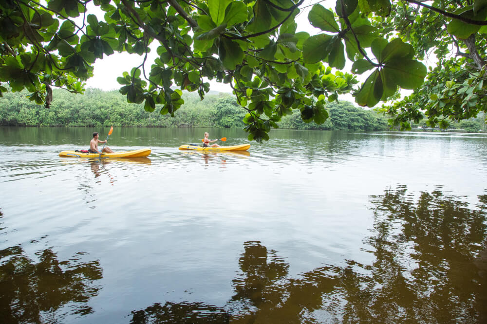 The Best 21 Free Things to do on Kauai with Kids featured by top Hawaii travel blog, Hawaii Travel with Kids: Wailua River is perfect for kayaking and leads to several Kauai waterfalls.