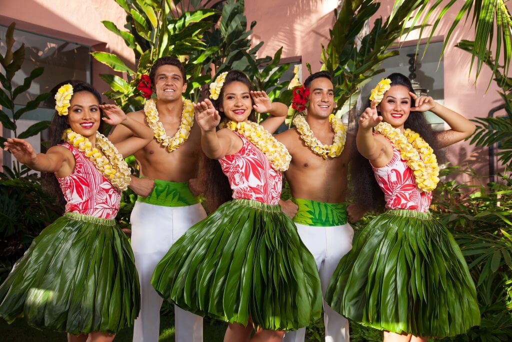 Hula dancers pose at the Aha Aina Luau on Oahu