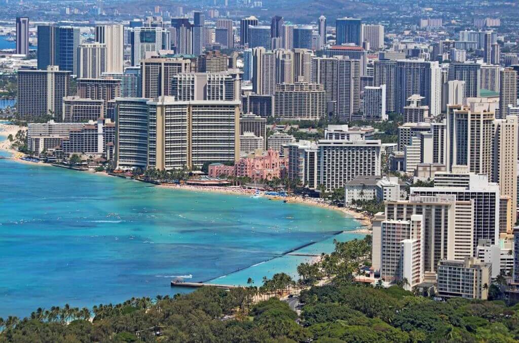 Find out where to stay in Hawaii by top Hawaii blog Hawaii Travel with Kids. Image of Waikiki jam packed with hotels.