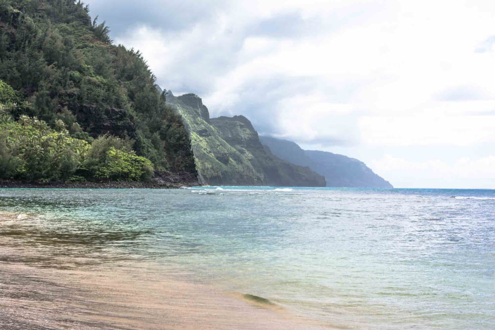 Top 9 Places for the Best Snorkeling on Kauai featured by top Hawaii travel blog, Hawaii Travel with Kids: Kee Beach is a popular snorkeling Kauai beach at the end of the road on Kauai