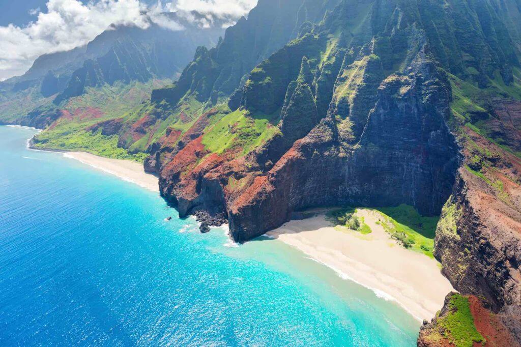 Image of the beautiful Na Pali Coast on Kauai with blue ocean and some hidden beaches among the cliffs.