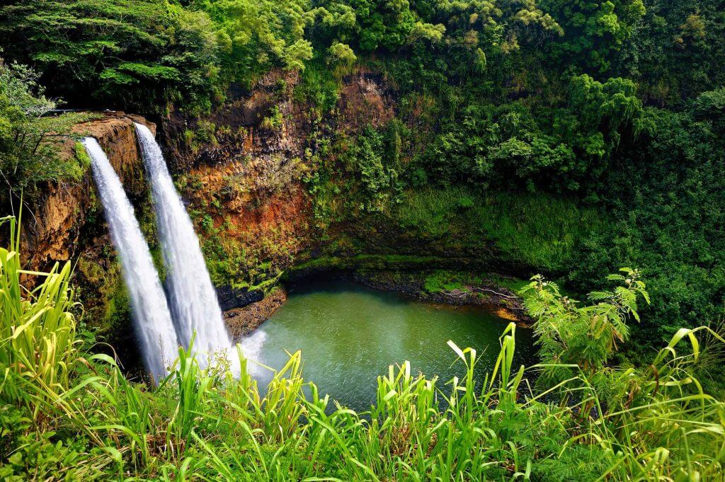 Wailua Falls was one of the Kauai filming locations you might have missed in the new Disney movie Jungle Cruise. Image of Wailua Falls on Kauai.