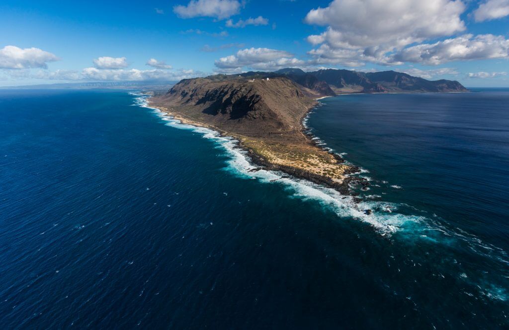 Another Oahu bucket list destination for nature lovers is Kaena Point. Image of a peninsula on Oahu.