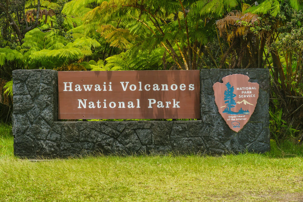 A visit to Hawaii Volcanoes National Park is a fun cheap thing to do on the Big Island of Hawaii. Image of the Hawaii Volcanoes National Park sign.