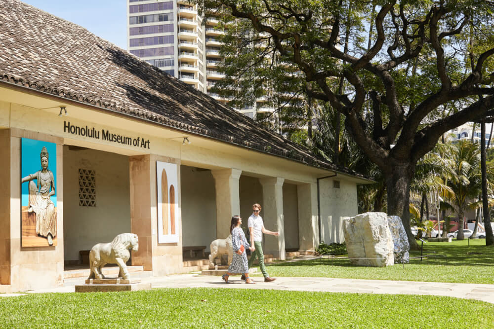 Things to Do in Hawaii with Kids: a review of Honolulu Museum of Art on Oahu featured by top Hawaii blog, Hawaii Travel with Kids: image of Couple walking out the entrance to the Honolulu Museum of Art on Oahu