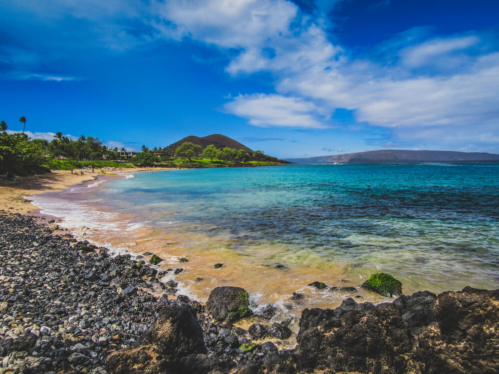 Where to See Turtles in Maui, tips featured by top Hawaii blog, Hawaii Travel with Kids: image of Tranquil turquoise-colored water on the quiet Maluaka Beach, Maui, Hawaii