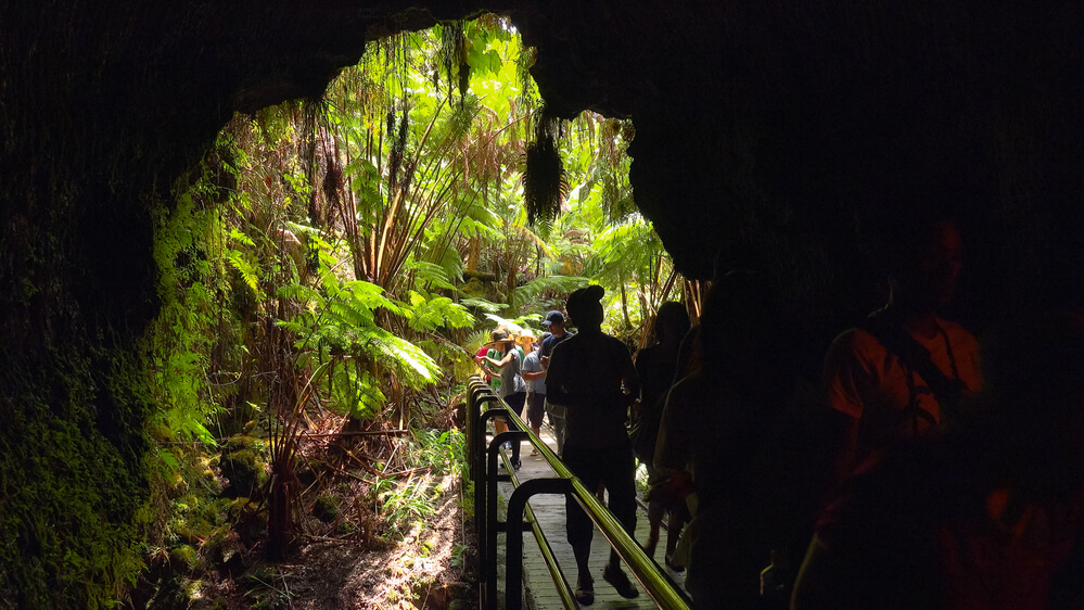 The Ultimate Guide to Hawaii Volcanoes National Park featured by top Hawaii blog, Hawaii Travel with Kids: Tourists entering the Thurston Lava Tube in Hawaii Volcanoes National Park