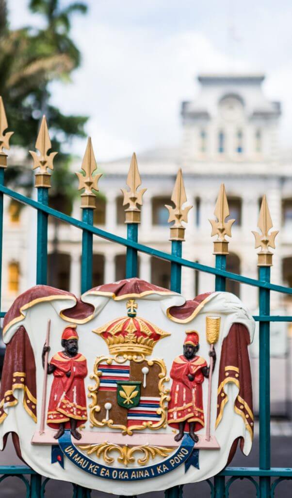 Iolani Palace is one of the most haunted places in Hawaii because that's where Queen Liliuokalani was imprisoned. Image of the Royal Seal on a gate to Iolani Palace on Oahu