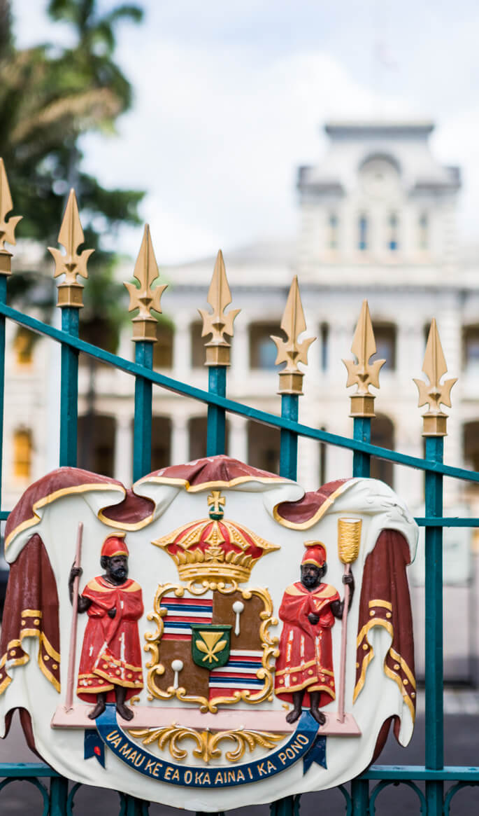 17 Historical Places in Hawaii to Visit with Kids featured by top Hawaii blog, Hawaii Travel with Kids: Royal Seal on a gate to Iolani Palace on Oahu