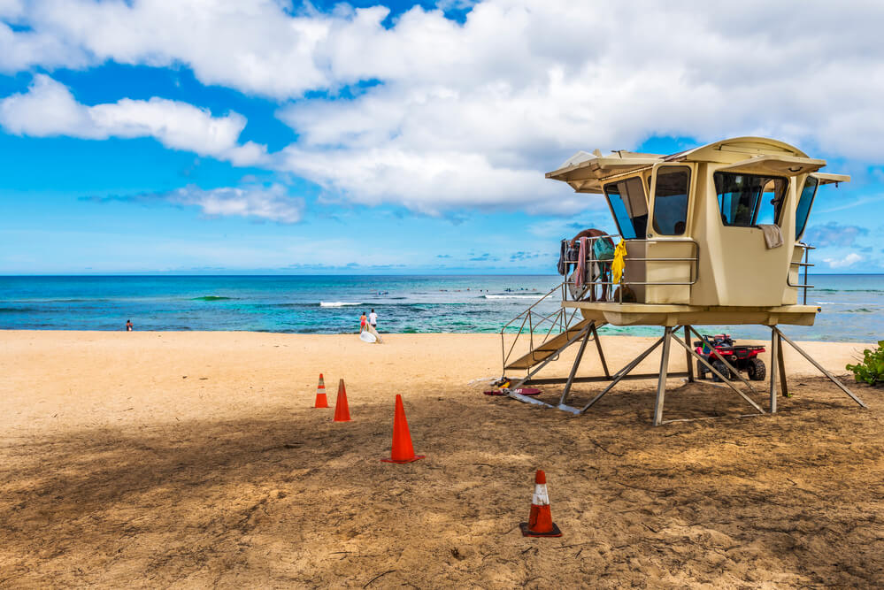 Oahu Surfing On The North Shore, a complete guide featured by top Hawaii blog, Hawaii Travel with Kids: Life guard tower at Laniakea beach in North Shore Oahu.