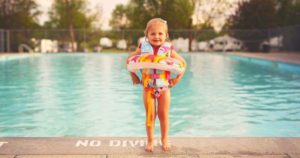 Child at the poool wearing one of the best life jackets for toddlers to stay safe and have fun