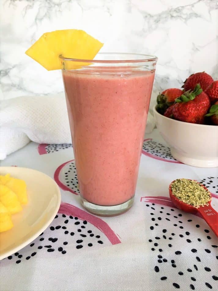 Hawaiian Tropical Smoothie Recipes to Make at Home featured by top Hawaii blog, Hawaii Travel with Kids: strawberry pineapple smoothie in large glass