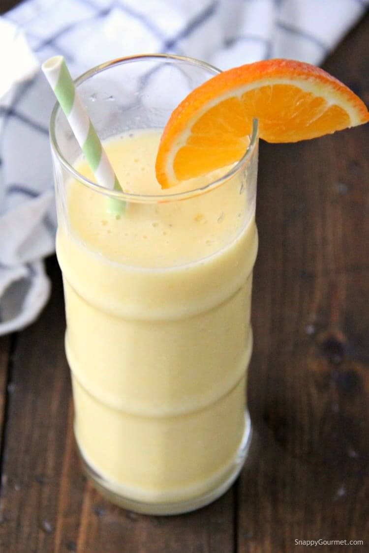 Hawaiian Tropical Smoothie Recipes to Make at Home featured by top Hawaii blog, Hawaii Travel with Kids: smoothie in tall glass with straw and orange slice