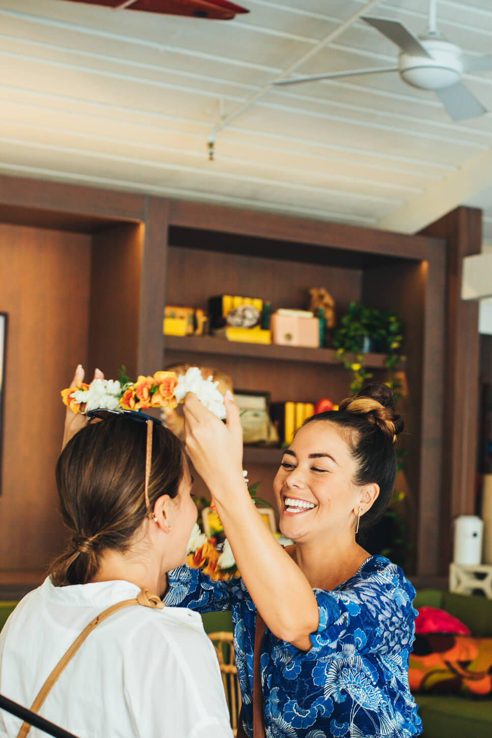 Hawaii Lei Day Celebrations + Activities for Kids featured by top Hawaii blog, Hawaii Travel with Kids: Woman greeting a friend with a lei