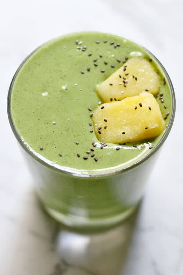 Hawaiian Tropical Smoothie Recipes to Make at Home featured by top Hawaii blog, Hawaii Travel with Kids: Kale Pineapple Smoothie topped with pineapple pieces and chia seeds