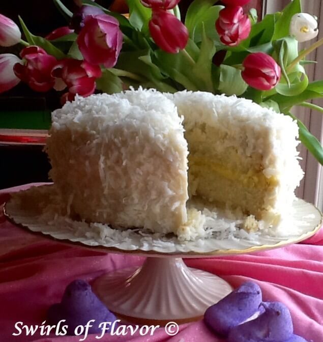 61 Delicious Coconut Dessert Recipes Perfect for Summer featured by top Hawaii blog, Hawaii Travel with Kids: Coconut Lemon Cake is a homemade coconut cake topped with coconut buttercream and flaked coconut. A tangy lemon filling makes every bite heaven!