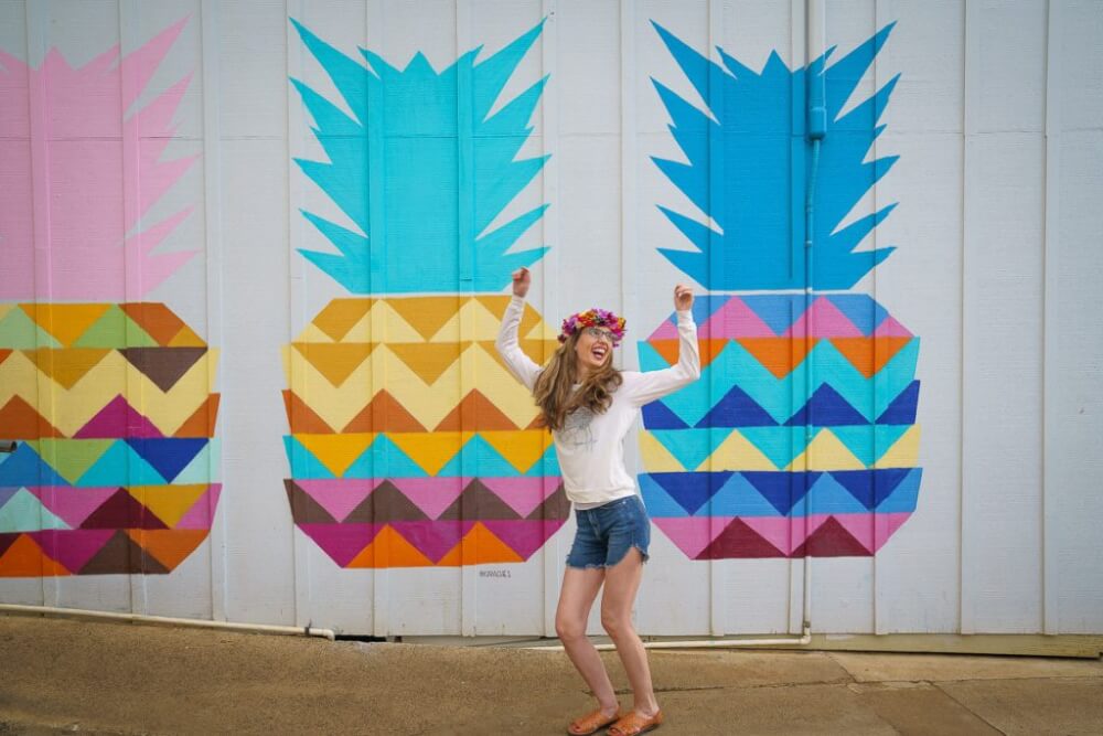 Top 12 Best Photo Opportunities on Kauai featured by top Hawaii travel blog, Hawaii Travel with Kids: The pineapple wall at Kauai Juice Co. in Kapaa is one of the most Instagrammable spots on Kauai.