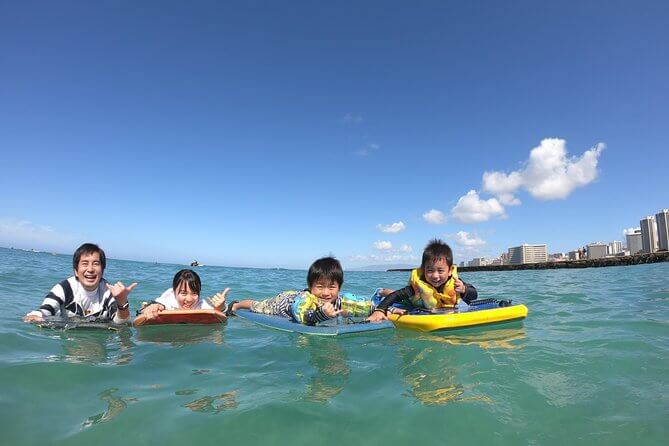 25 Amazing activities in Waikiki with kids featured by top Hawaii blog, Hawaii Travel with Kids: Family bodyboarding in Waikiki with kids