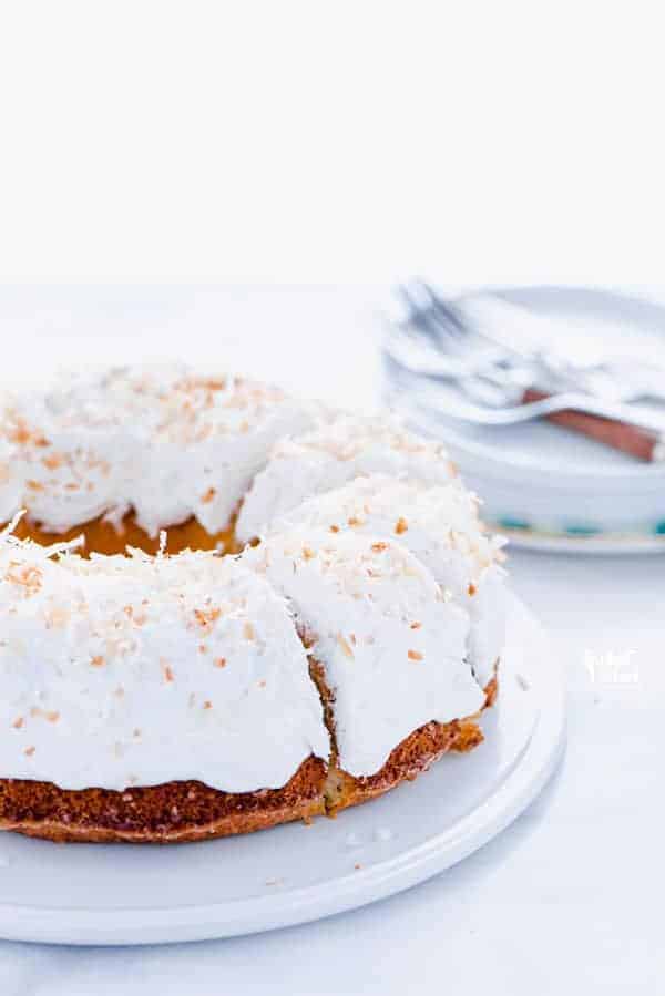 61 Delicious Coconut Dessert Recipes Perfect for Summer featured by top Hawaii blog, Hawaii Travel with Kids: This is a simple, easy recipe for Coconut Pound Cake - aka Coconut Bundt Cake. It’s full of coconut flavor from coconut extract and shredded coconut and is topped with the most delicious, creamy coconut icing and garnished with toasted coconut. It’s a perfect dessert for a crowd or for holidays, birthday cake, and gatherings. It’s moist, dense, and has a tender crumb that’s addicting. Gluten Free Cake recipe from @whattheforkblog - visit whattheforkfoodblog.com for more gluten free desserts.