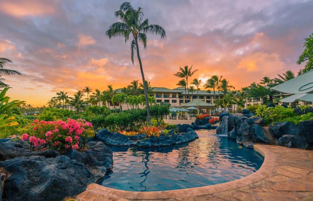 The Grand Hyatt Kauai is one of the best kid friendly resorts on Kauai. Image of the Grand Hyatt Kauai Pools at sunset.