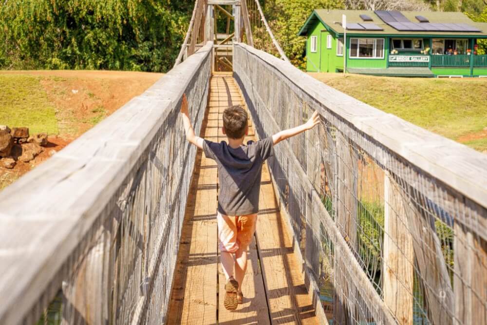 101 Best Things to Do on Kauai with Kids featured by top Hawaii blog, Hawaii Travel with Kids: Hanapepe Swinging Bridge is a fun Kauai activity for kids