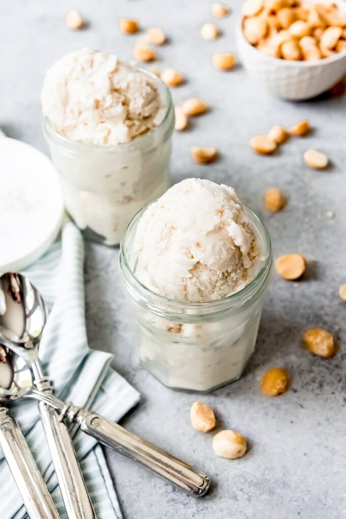 61 Delicious Coconut Dessert Recipes Perfect for Summer featured by top Hawaii blog, Hawaii Travel with Kids: An image of two glass cups filled with scoops of homemade coconut macadamia nut ice cream.