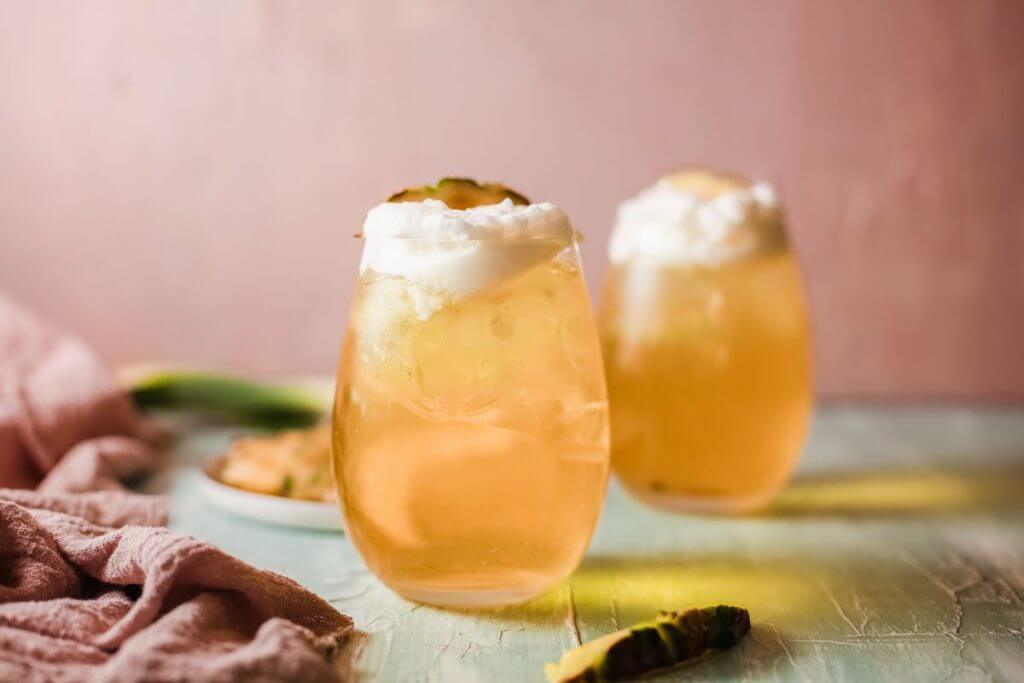 The best Hawaiian Mai Tai cocktail recipe from Hawaii blog Hawaii Travel with Kids. Image of two glasses filled with Mai Tai cocktails.