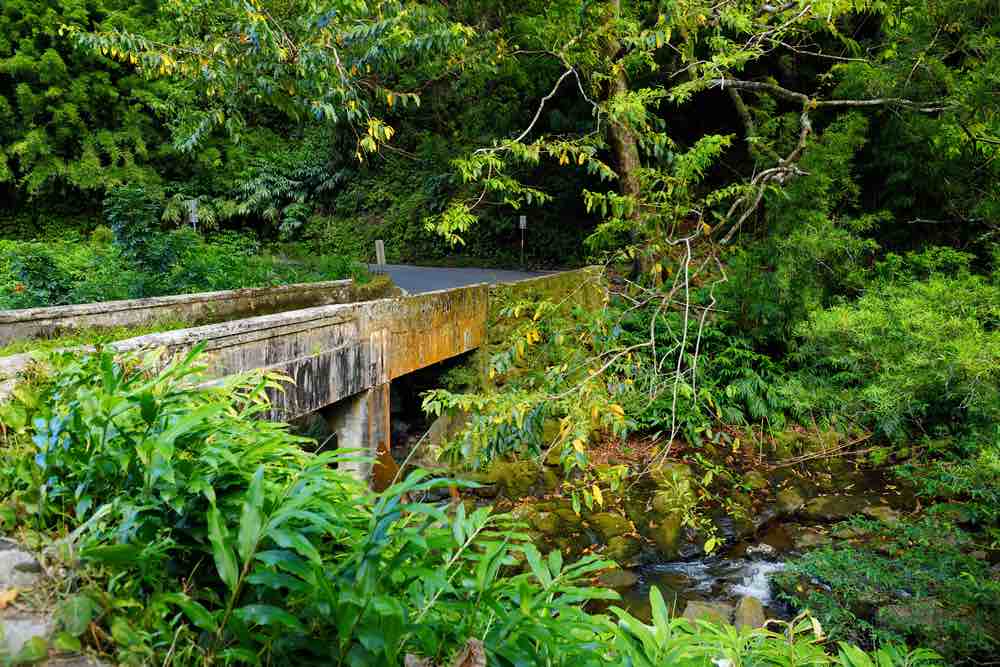 17 Historical Places in Hawaii to Visit with Kids featured by top Hawaii blog, Hawaii Travel with Kids: Road to Hana bridge on Maui