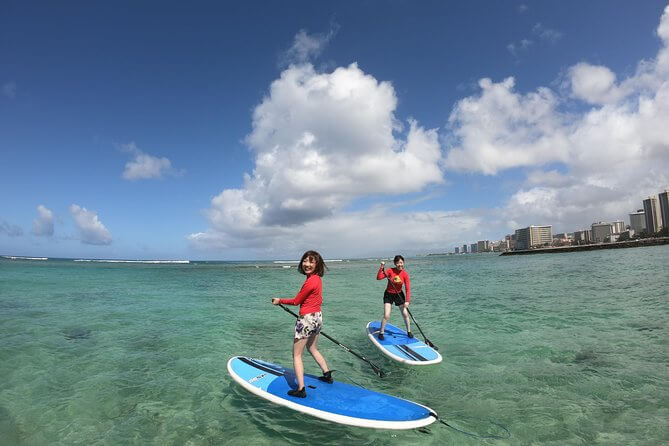 25 Amazing activities in Waikiki with kids featured by top Hawaii blog, Hawaii Travel with Kids: Stand Up Paddleboarding in Waikiki