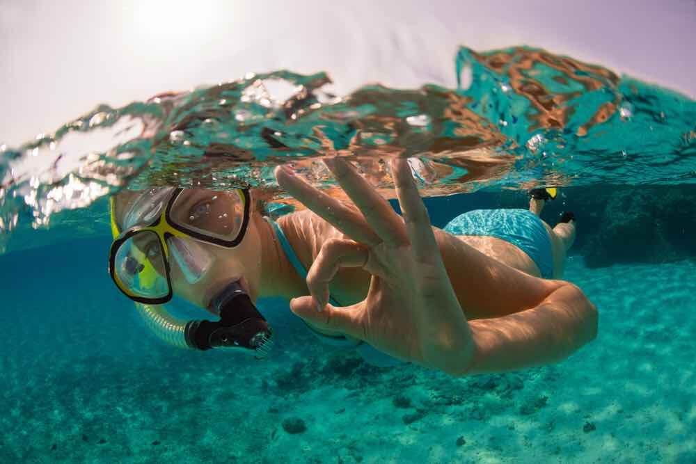 Snorkeling woman exploring beautiful ocean sealife, underwater photography. Travel lifestyle, water sport outdoor activities, swimming and snorkeling on summer beach holidays.