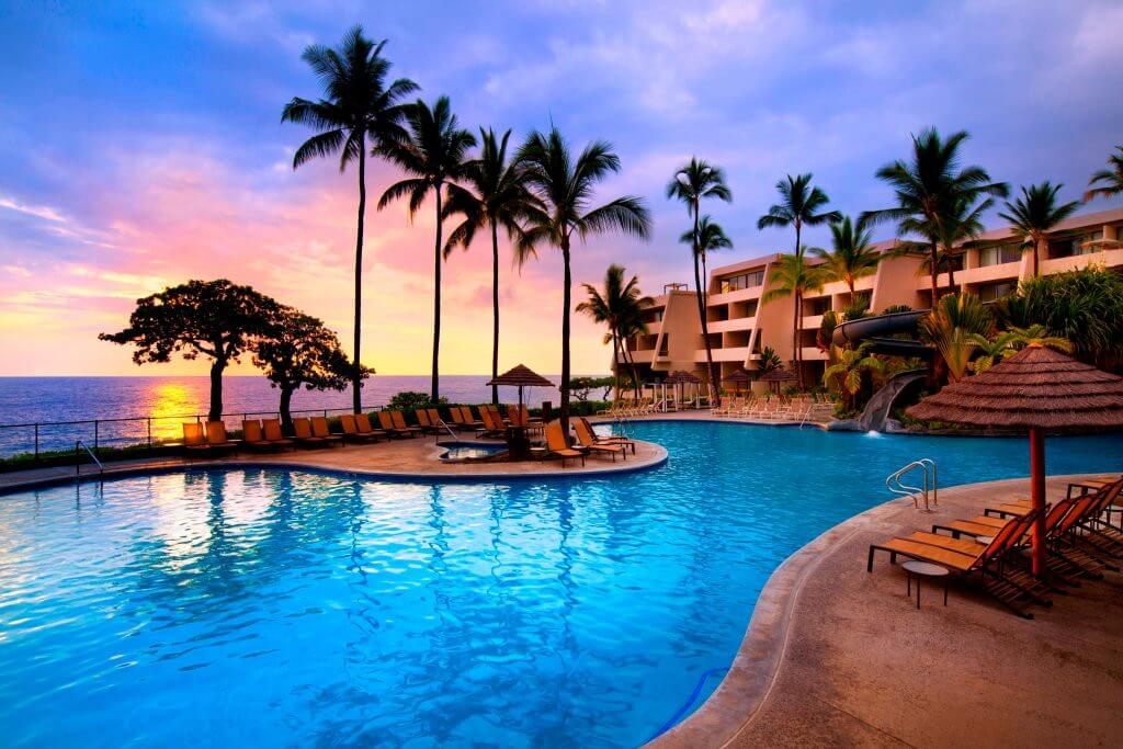 The Sheraton Kona Resort & Spa is another best place to stay on Big Island with kids. Image of the pool area overlooking the beach.