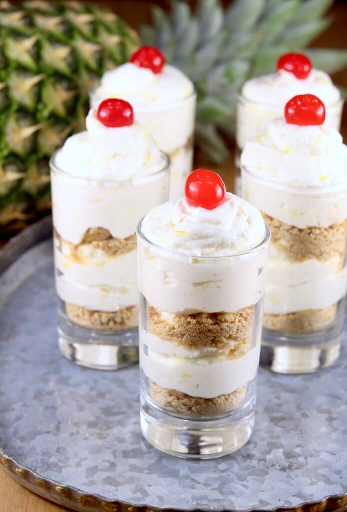 Pineapple Dessert Recipe Roundup by top Hawaii blog Hawaii Travel with Kids: Pineapple Cheesecake Parfaits with cherry garnish