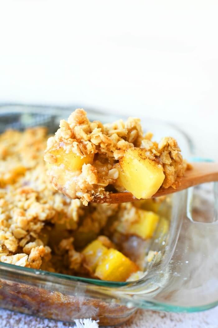 Pineapple Dessert Recipe Roundup by top Hawaii blog Hawaii Travel with Kids: Pineapple baked crisp on spoon.