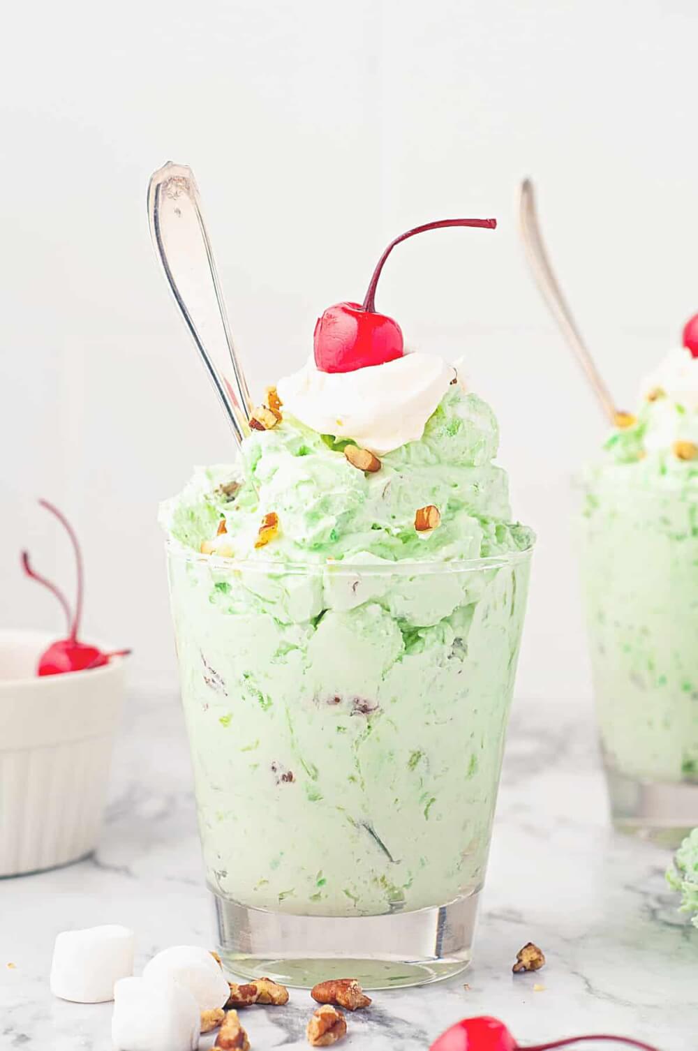 Pineapple Dessert Recipe Roundup by top Hawaii blog Hawaii Travel with Kids: Watergate Salad in a glass with whipped topping and a cherry on top