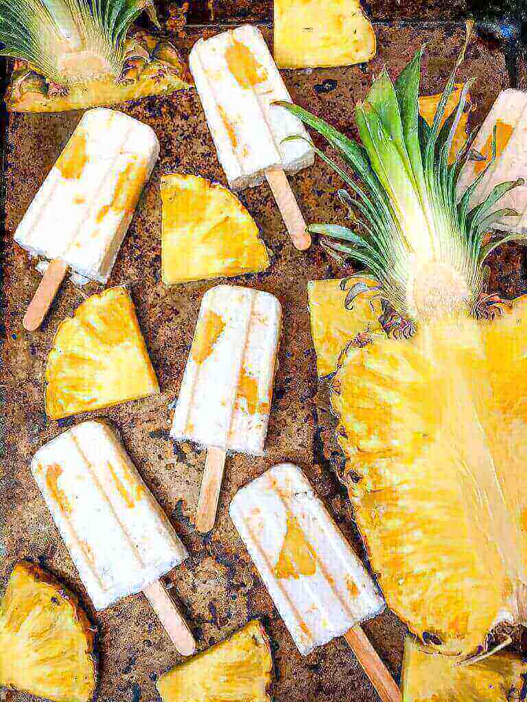 Pineapple Dessert Recipe Roundup by top Hawaii blog Hawaii Travel with Kids: Pina Colada Popsicles are easy and healthy homemade popsicles made with coconut milk and pineapple. Add rum if desired for an alcohol popsicle poptail. Gluten free and vegan. #homemadepopsicles #pinacolada #coconutpopsicles