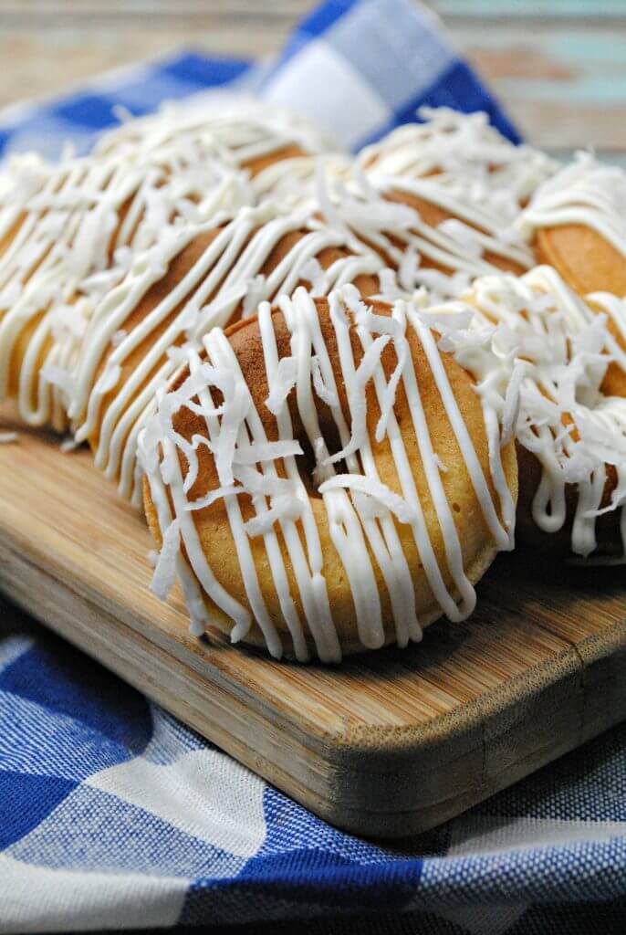 Pineapple Dessert Recipe Roundup by top Hawaii blog Hawaii Travel with Kids: Doughnuts with crazy flavors are all the rage, and these Pineapple Doughnuts are the perfect easy recipe for a lazy weekend! Made with real pineapple and coconut, your family will love the tropical flavors.