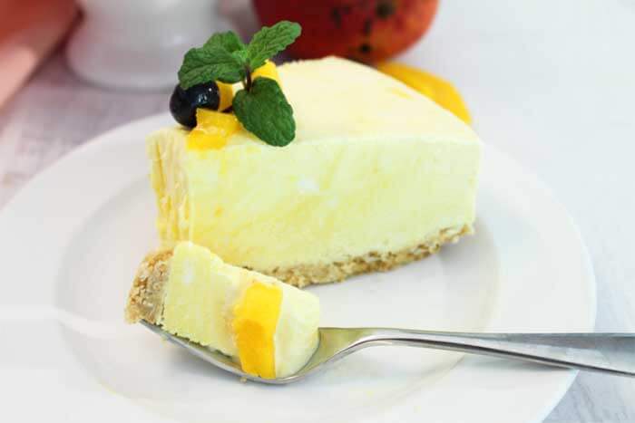 Best Mango dessert recipes by top Hawaii blog Hawaii Travel with Kids: Mango Pineapple Icebox Cheesecake slice with bite