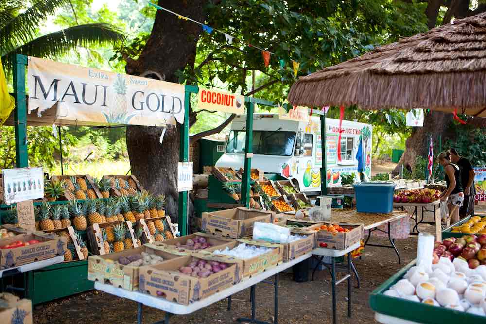 Maui Farmers Markets you need to know about by top Hawaii blog Hawaii Travel with Kids. Image of a farmers market on Maui.