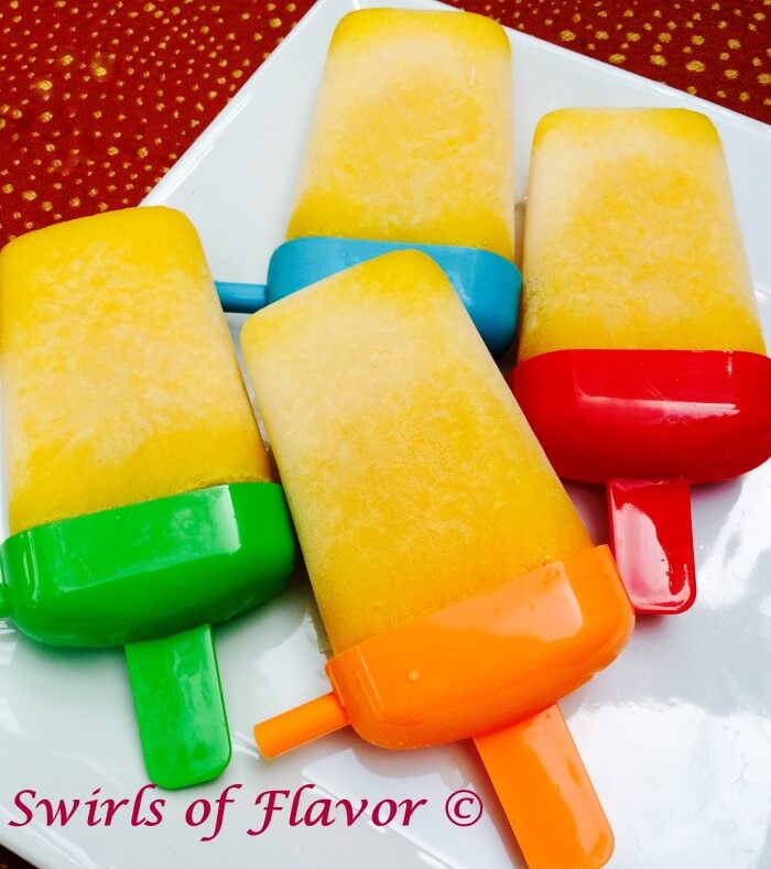 Pineapple Mango Ice Pops combine the sweet buttery mango with the tart mouthwatering pineapple and a hint of lime for a tropical frozen treat. Fun for kids | mango | pineapple | popsicles | frozen dessert | dessert | tropical fruit | summer dessert | #swirlsofflavor | easy recipe