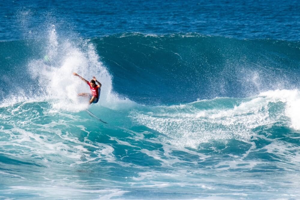 Oahu Surfing On The North Shore, a complete guide featured by top Hawaii blog, Hawaii Travel with Kids: Sheldon Simkus at the Vans World Cup of Surfing. Photo credit: WSL/Keoki