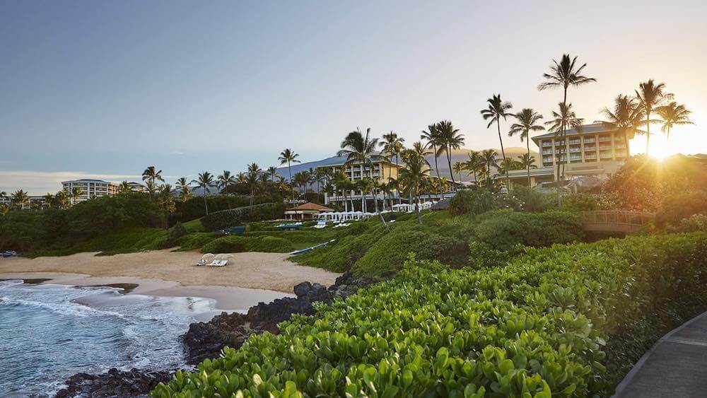 Top 5 Best Maui Luxury Hotels featured by top Hawaii blogger, Hawaii Travel with Kids: The Four Seasons Maui is a top Maui Luxury Resort perfect for couples. Image of the exterior of a waterfront hotel in Maui