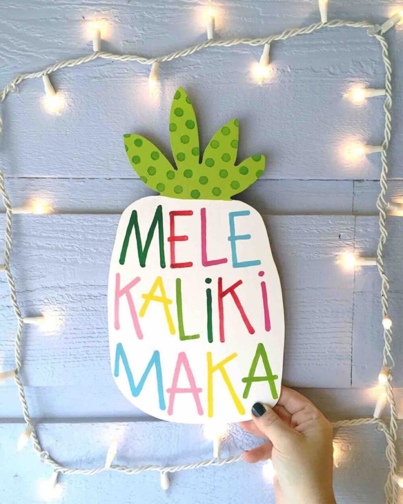 Best Hawaiian Christmas Decorations featured by top Hawaii blogger, Hawaii Travel with Kids: Add some Hawaiian Christmas decorations to your home this holiday season with these top Hawaii Christmas decorations ideas from top Hawaii blog Hawaii Travel with Kids: image of a Mele Kalikimaka pineapple sign