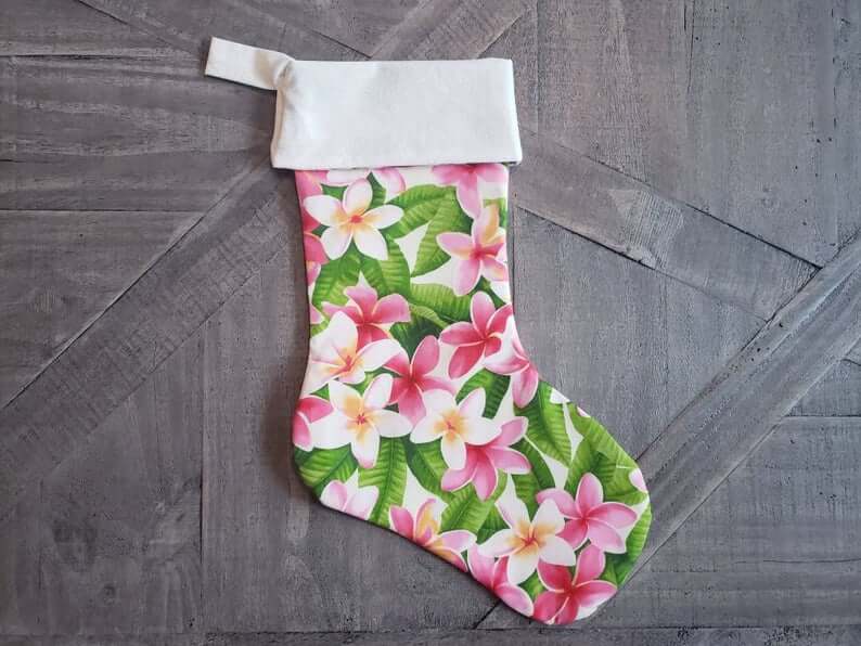 Best Hawaiian Christmas Decorations featured by top Hawaii blogger, Hawaii Travel with Kids: Add some Hawaiian Christmas decorations to your home this holiday season with these top Hawaii Christmas decorations ideas from top Hawaii blog Hawaii Travel with Kids. Image of Hawaiian Plumeria Christmas Stocking