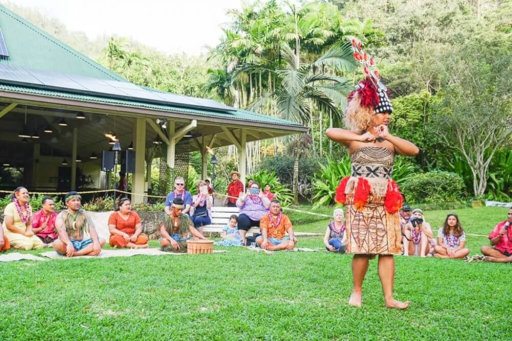 If you're looking for an authentic luau, Toa Luau in North Shore Oahu is pretty amazing. Image of a Samoan dancer performing with audience members in the background.