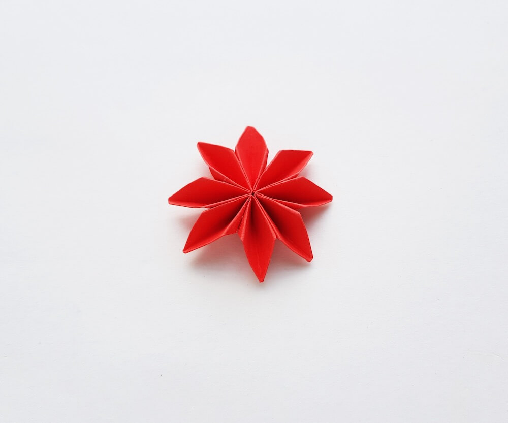 How to Make Origami Poinsettia Flowers, a Hawaiian Christmas craft tutorial featured by top Hawaii blogger, Hawaii Travel with Kids: Image of a paper poinsettia flower