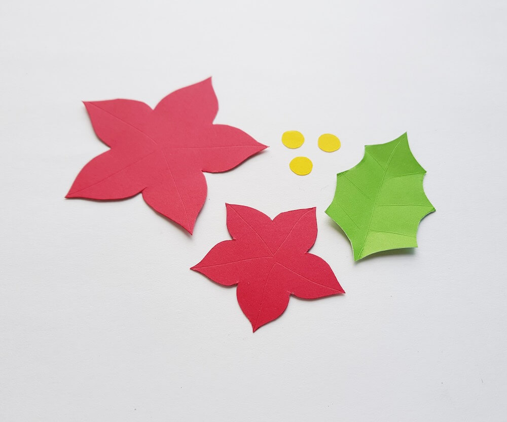 How to Make a Paper Poinsettia Craft, a tutorial featured by top Hawaii blog, Hawaii Travel with Kids: image of pieces of paper cut out and scored