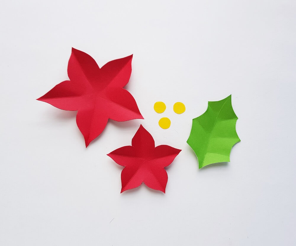 How to Make a Paper Poinsettia Craft, a tutorial featured by top Hawaii blog, Hawaii Travel with Kids: Image of pieces of paper cut out and folded