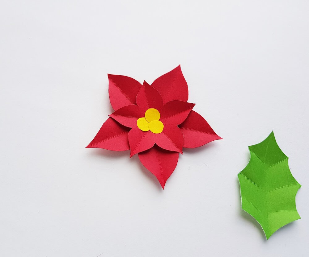 How to Make a Paper Poinsettia Craft, a tutorial featured by top Hawaii blog, Hawaii Travel with Kids: Image of a paper poinsettia glued